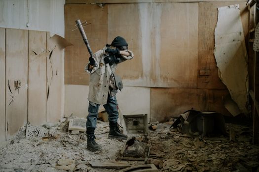 A dramatic post-apocalyptic scene with a masked figure holding a weapon in a dilapidated room.