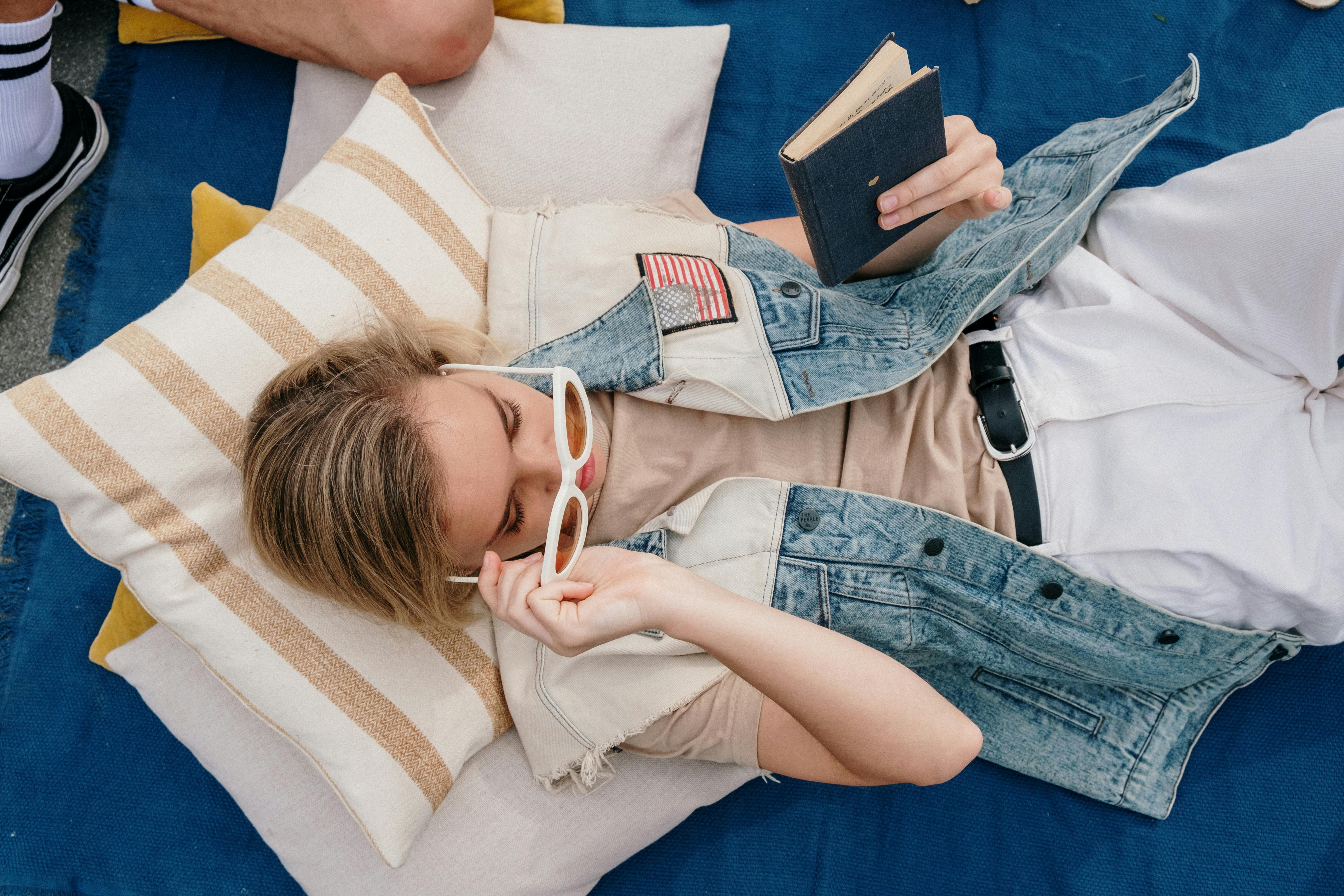 woman in white shirt lying on bed