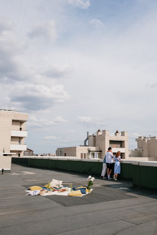 Man in White Shirt Walking on Gray Concrete Road