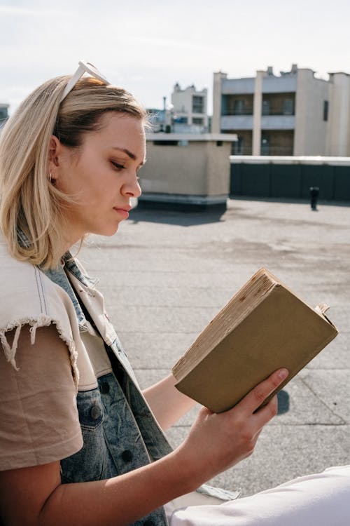 Woman in Brown Coat Holding Brown Cardboard Box