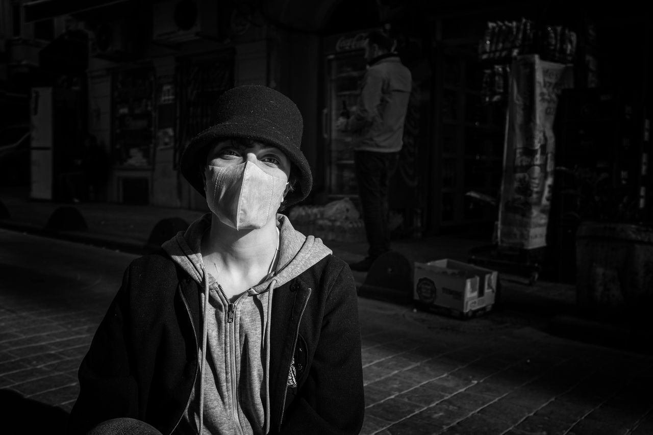 black and white portrait of a person wearing a mask on istanbul street