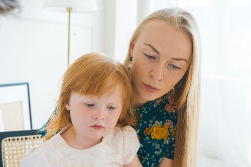 Free A tender moment capturing a mother and daughter bonding together indoors. Stock Photo