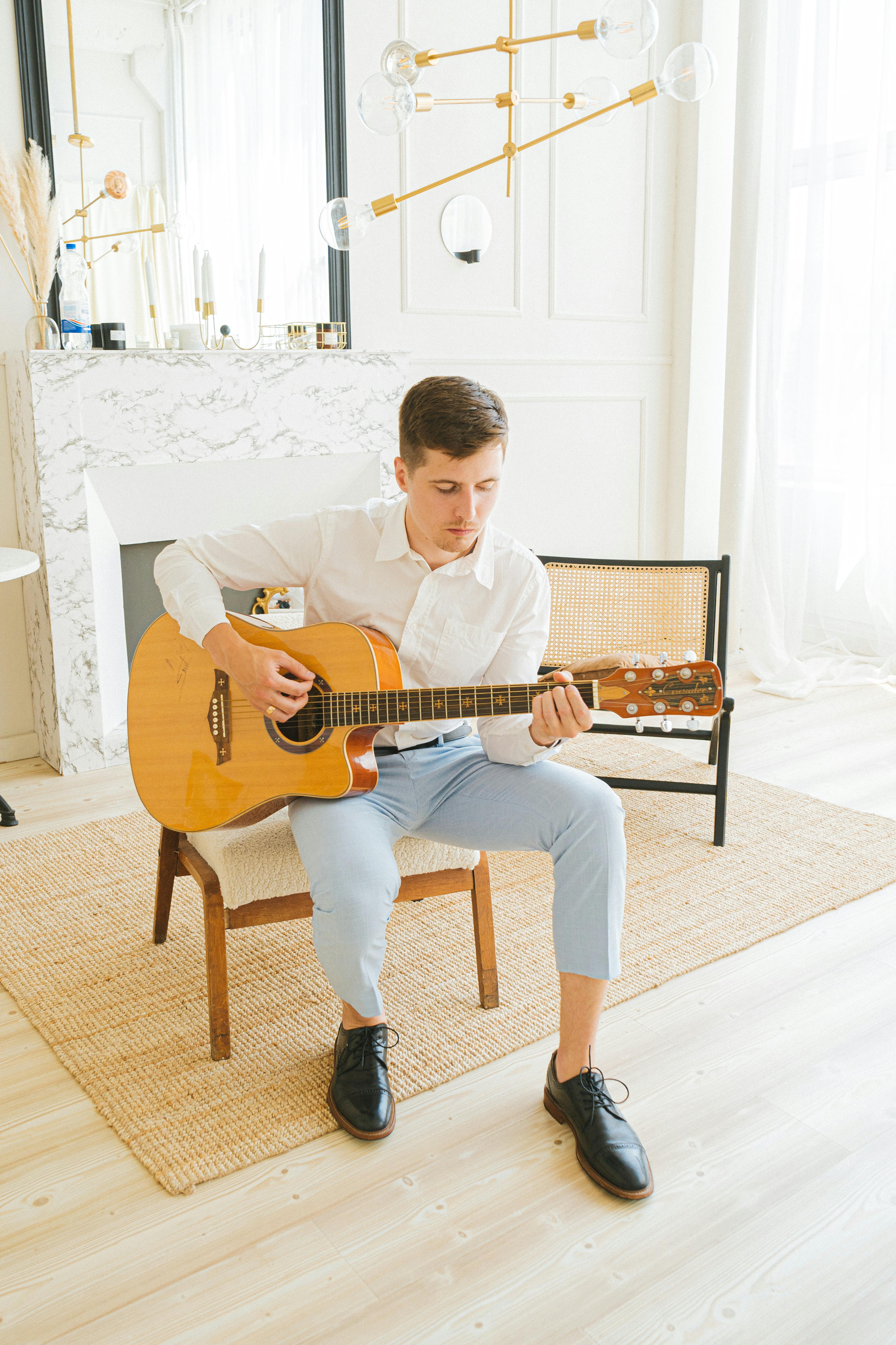 Boy in White Crew Neck T-shirt Playing Brown Acoustic Guitar · Free