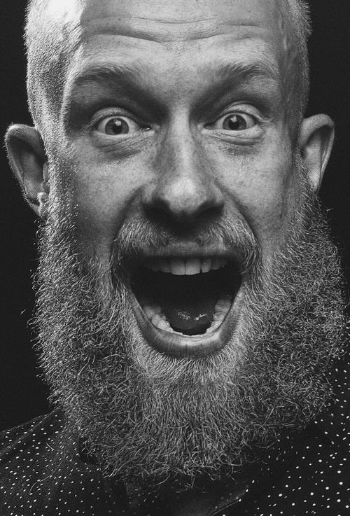 Free Close-up monochrome portrait of a bearded man with an expressive face, conveying strong emotion. Stock Photo