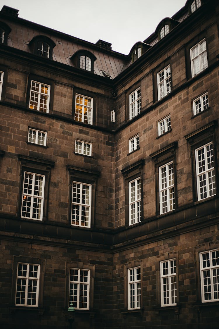 A Brown Bricks Of Building With Sash Windows