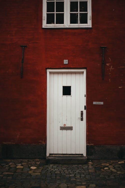Free White Wooden Door and Window on a Red Wall Stock Photo