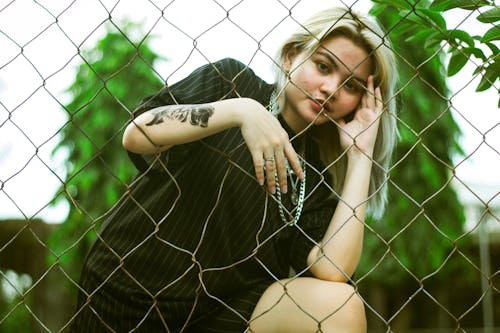 Woman Behind the Chain Link Fence
