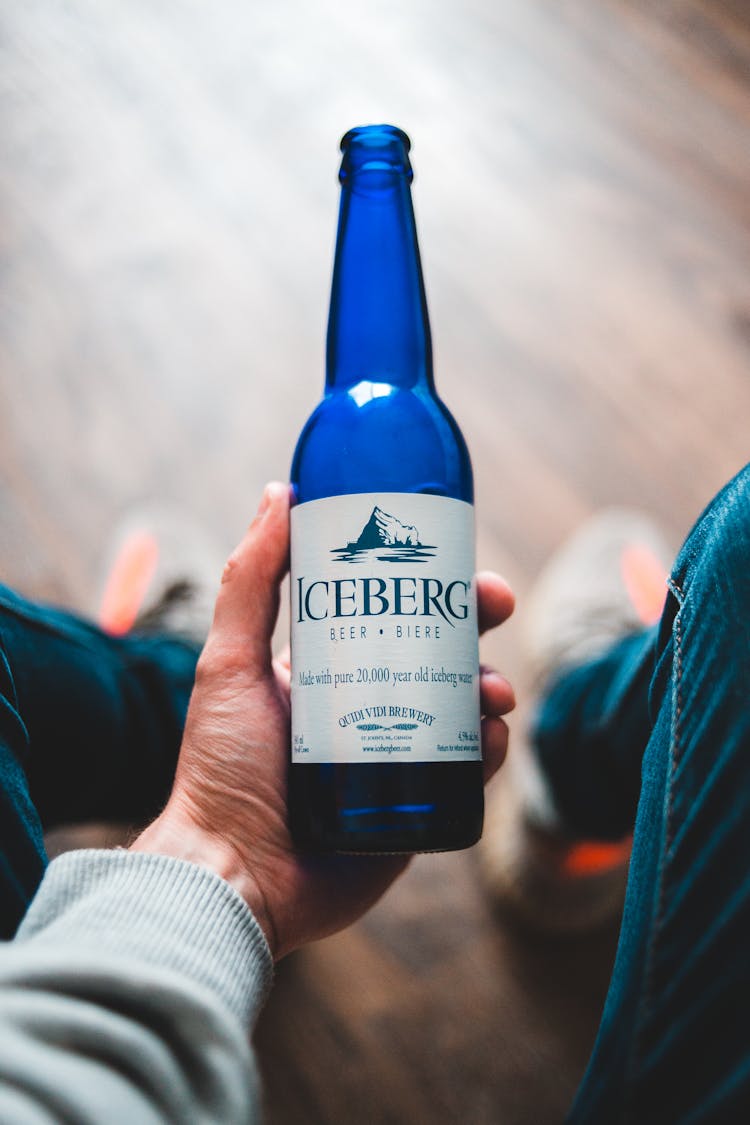 Bottle Made Of Blue Glass In Hand