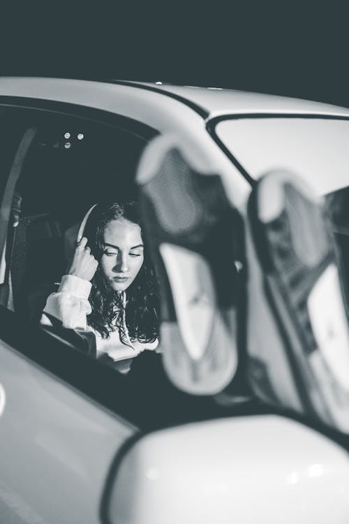 Free Attractive young woman in white car Stock Photo