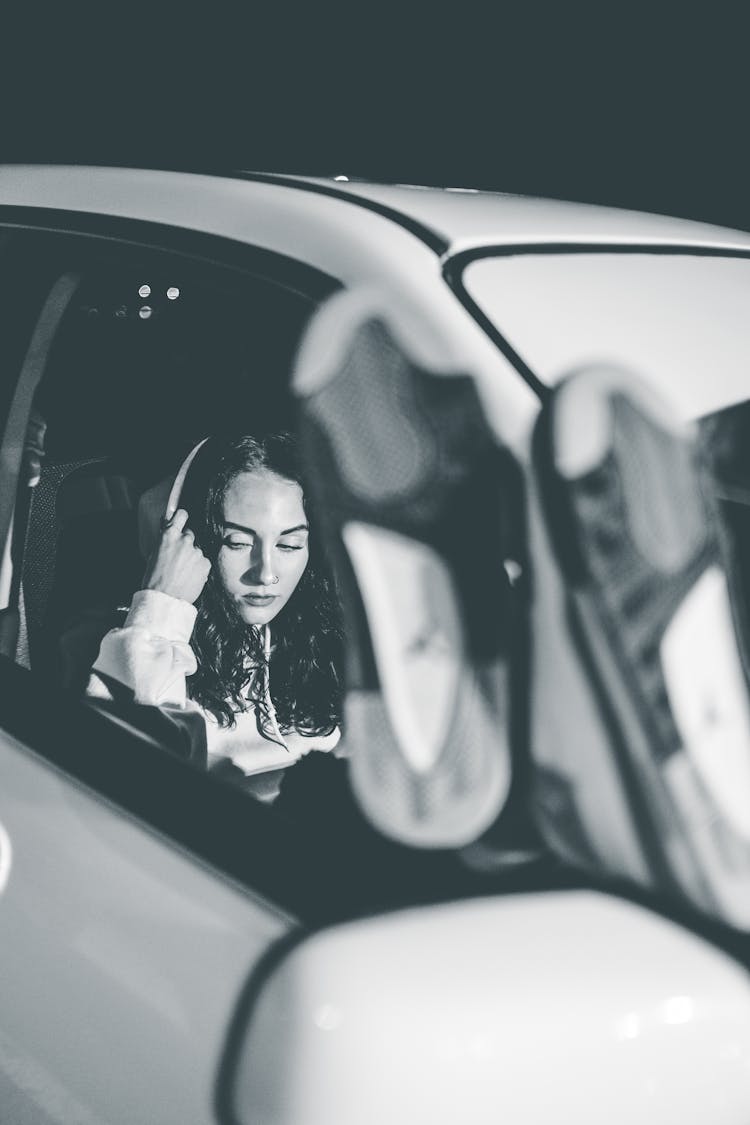 Attractive Young Woman In White Car