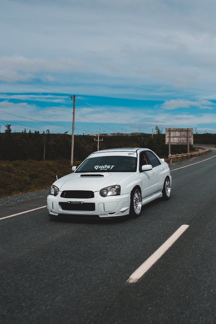 Tuned Sports Car Riding On Paved Road