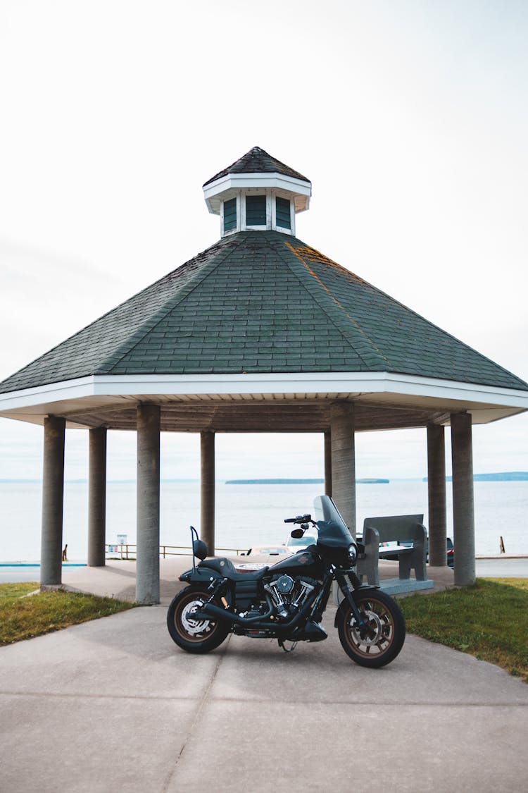 Classical Motorcycle By Rotunda Next To Lake