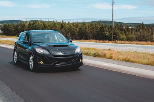 Tuned sports car riding on asphalt road