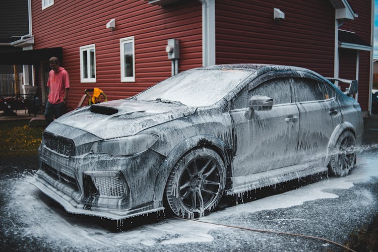 Faceless Black Man Standing Near Automobile At Car Wash