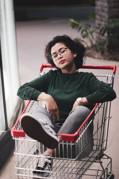 Woman Riding on a Shopping Cart