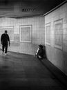 Poor musician sitting in brick tunnel