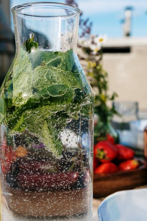 Free Infused water with mint leaves and strawberries, perfect for a refreshing summer brunch. Stock Photo