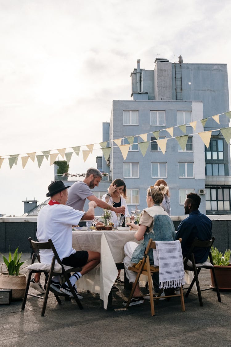 People Sitting On Chairs Near Building