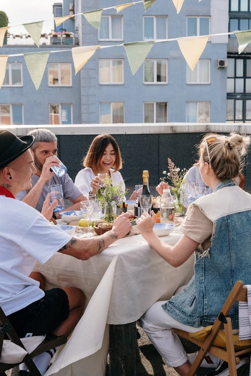 Group of People Sitting on Chair in Front of Table