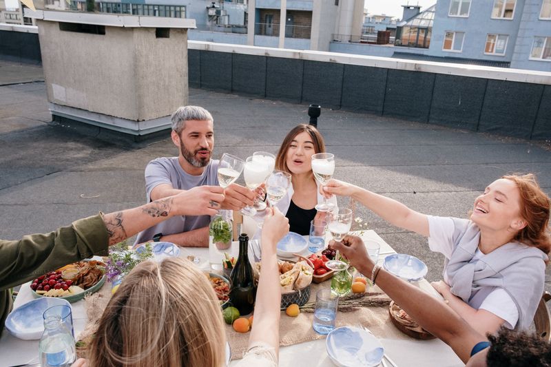 Friends toasting over a rooftop dinner — photo by cottonbro studio on Pexels