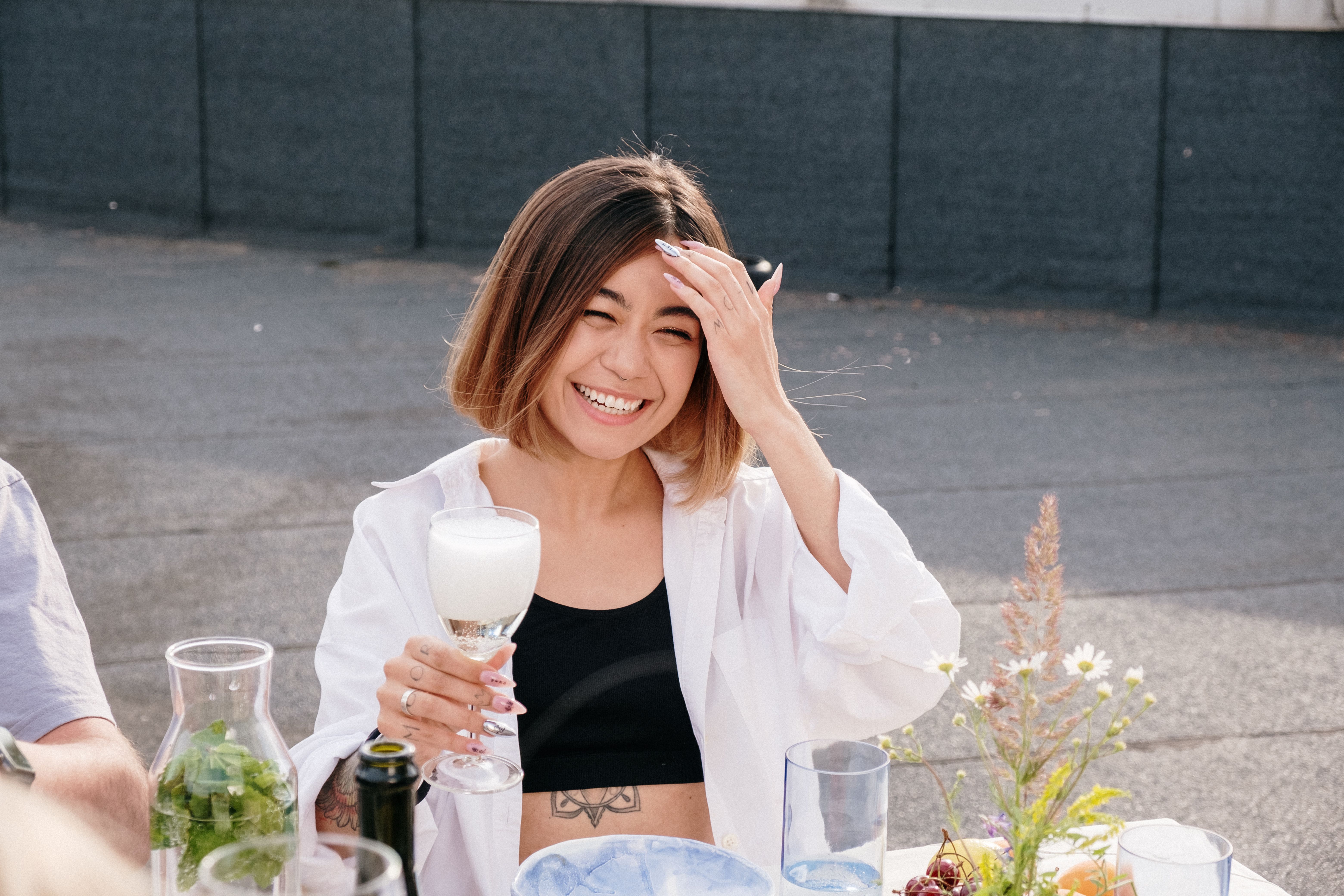 Woman in White Long Sleeve Shirt Holding Clear Drinking Glass · Free ...