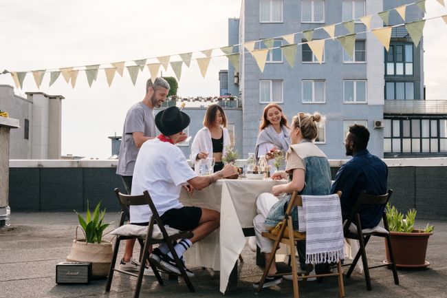 A long lunch table set up on a rooftop — photo by cottonbro studio on Pexels
