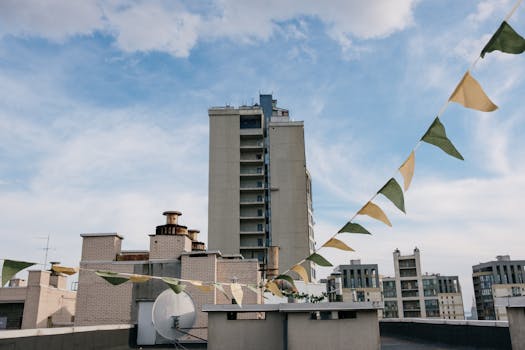 City rooftop scene with decorative bunting under a clear sky. Urban living style.