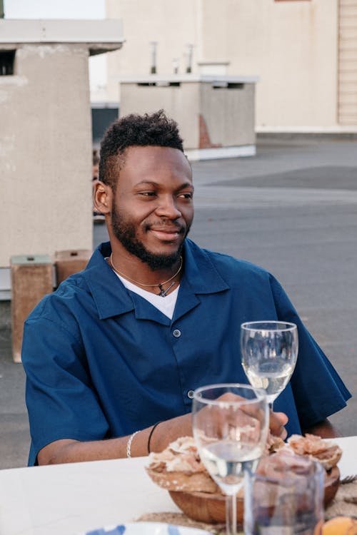 Man in Blue Dress Shirt Holding Clear Wine Glass