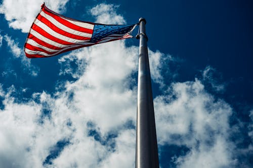 Free American Flag On Pole Under Blue Sky Stock Photo