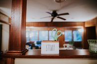 Scissors in small wooden box with handwritten word Stuff placed on counter in modern office
