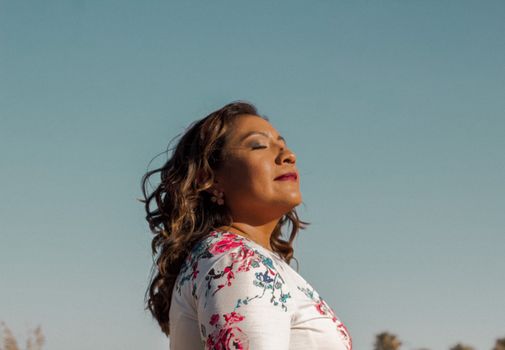 Person breathing deeply outdoors during a workout