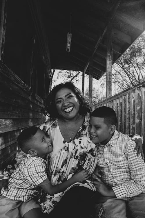 Grayscale Photo Of Woman With Her Children