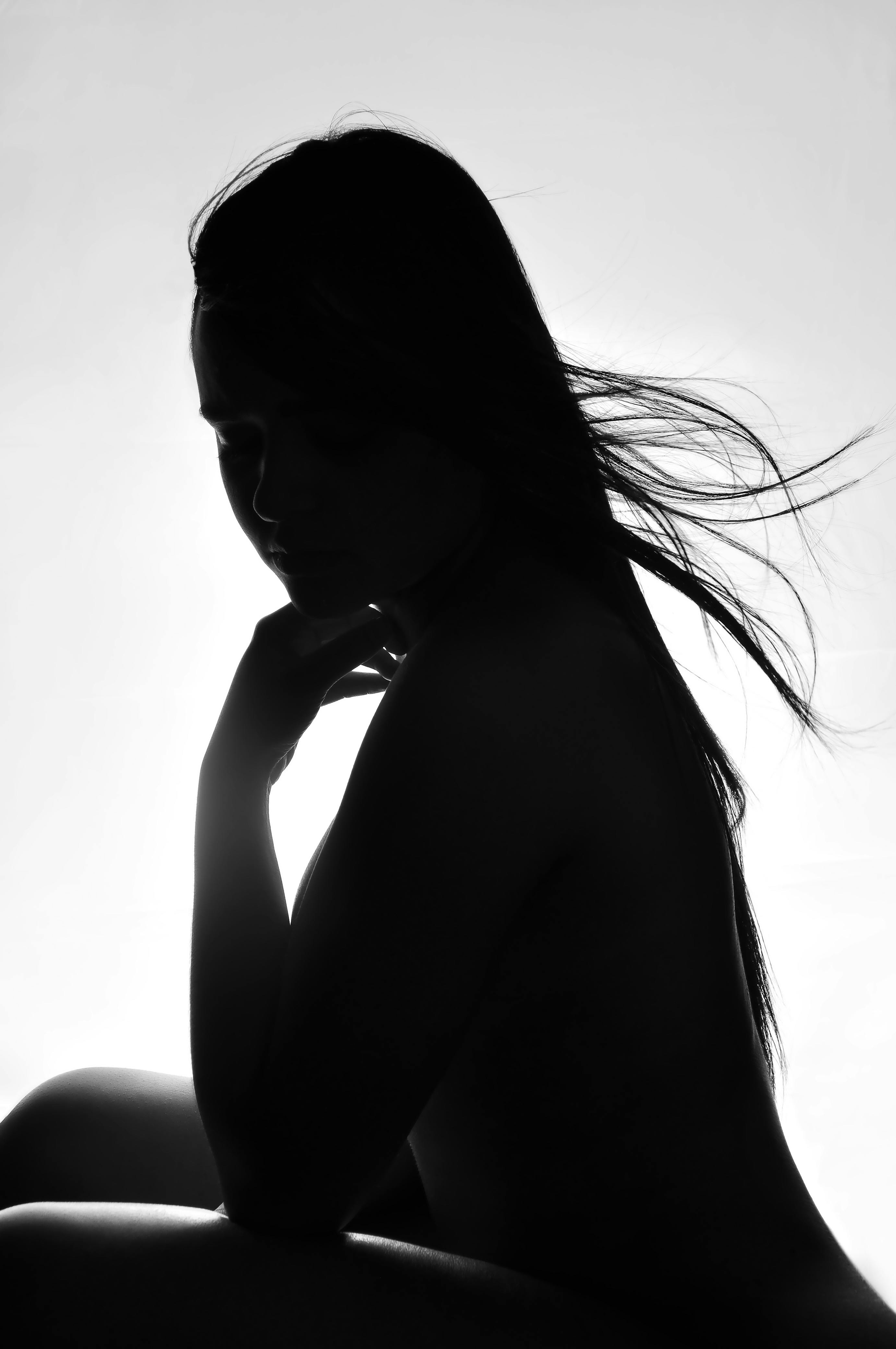 Woman Wearing White Angel Wings Sitting on Ground While Leaning Her ...