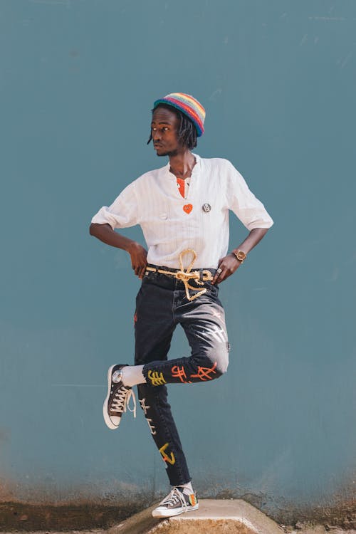 Man In White Shirt And Denim Jeans Wearing A Beanie