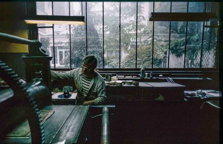 Man Working At Old Printing Press