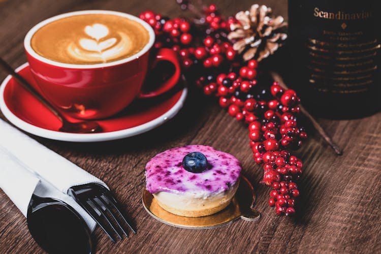 Blueberry Cheesecake Beside A Cup Of Coffee