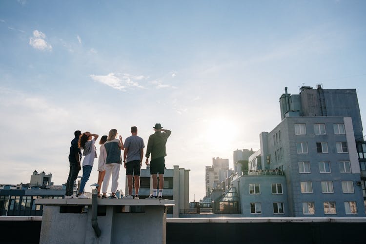 People Standing On Top Of Building