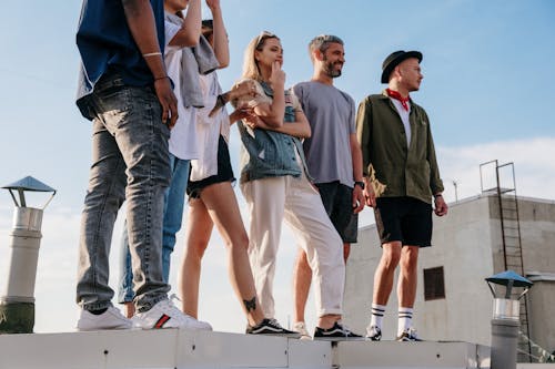 Group of People Standing on White Concrete Wall