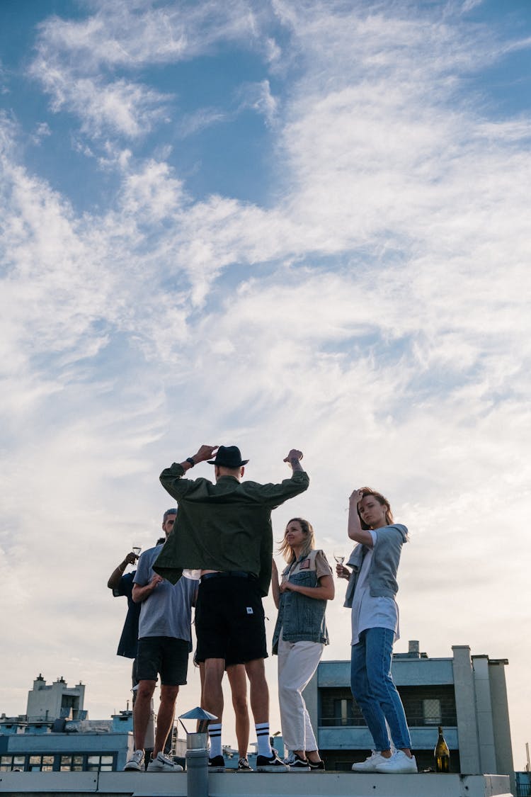 Group Of People Standing Under White Clouds