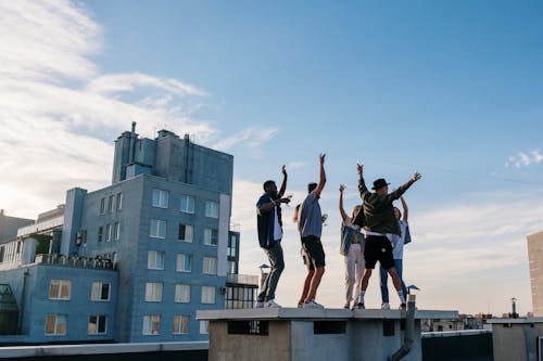 Free 3 Men Jumping on Top of Building Stock Photo