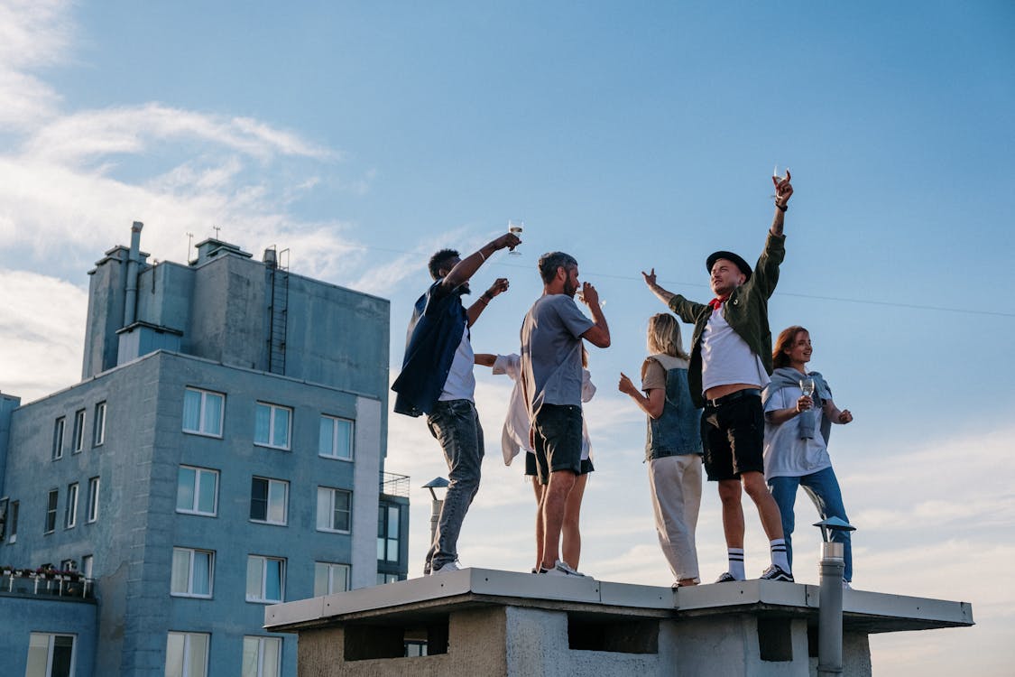 Free Group of People Standing on Top of Building Stock Photo