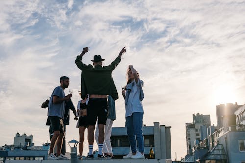 Free Group of People Standing on Top of Building Stock Photo