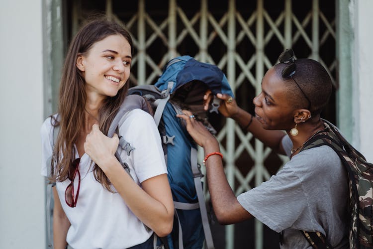 Happy Girls With Backpacks In City