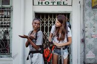 2 Women Standing Beside White Door