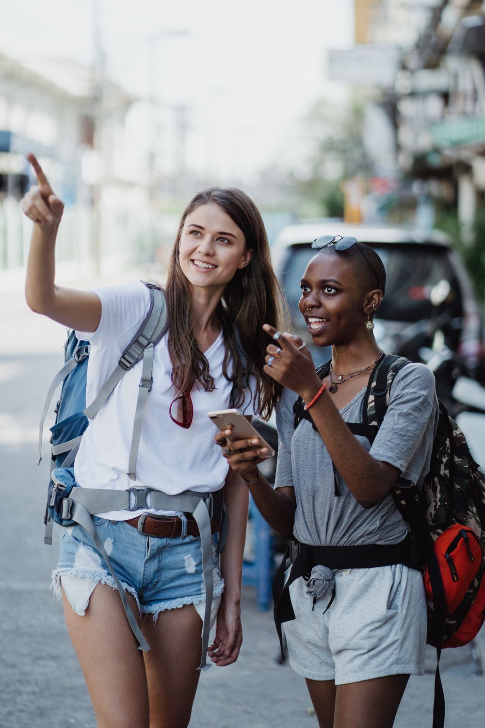 Friends sightseeing in a city with backpacks