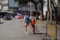 Woman in Blue Denim Jacket and Blue Denim Shorts Walking on Street