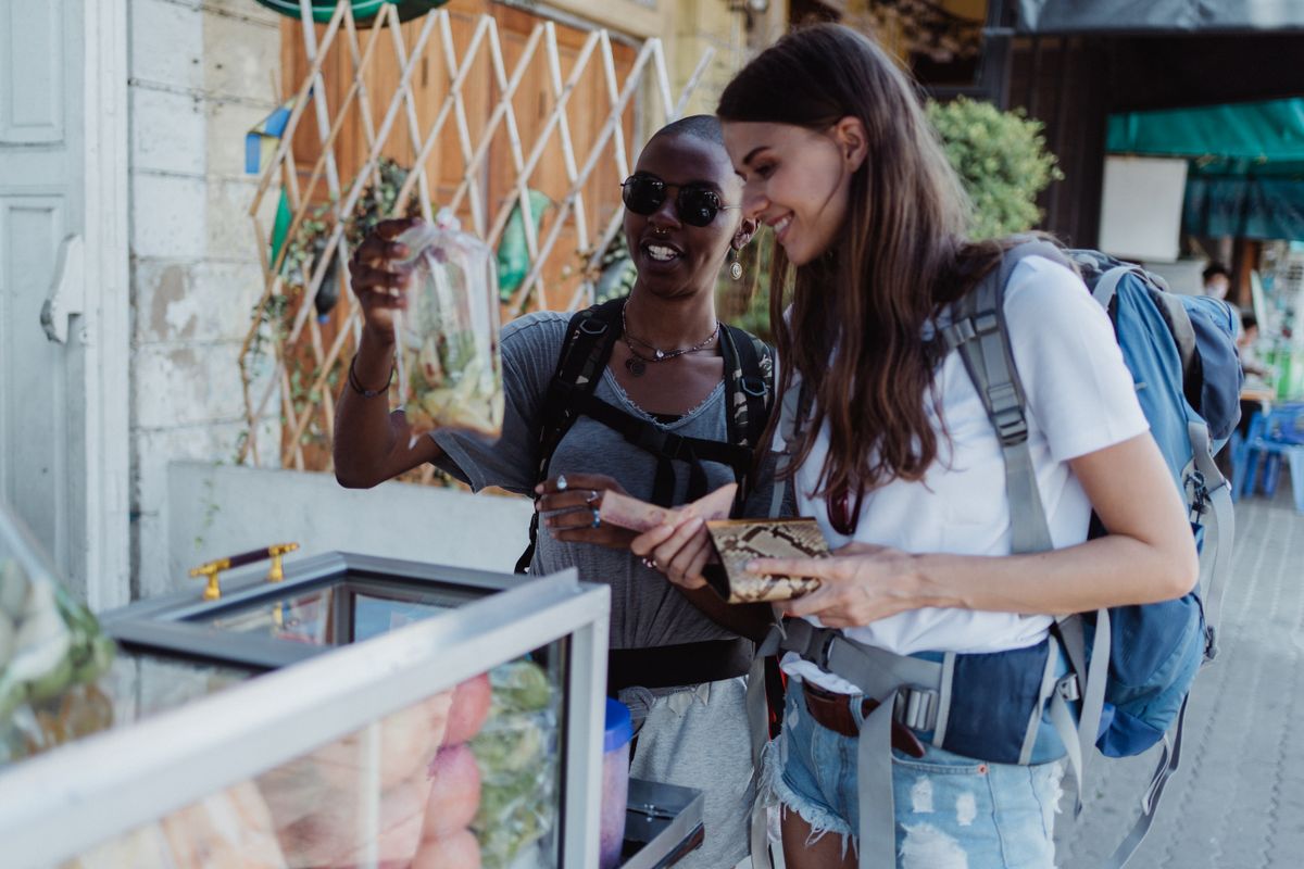 Two people browsing a colourful local market