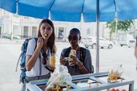 Two Women Eating on the Street