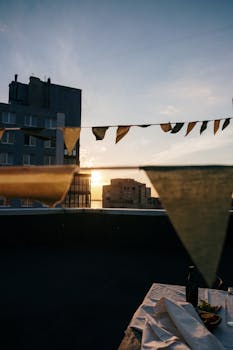 City rooftop festivity with decorative bunting and sunset view.