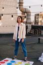 Woman in White Coat Standing on Sidewalk